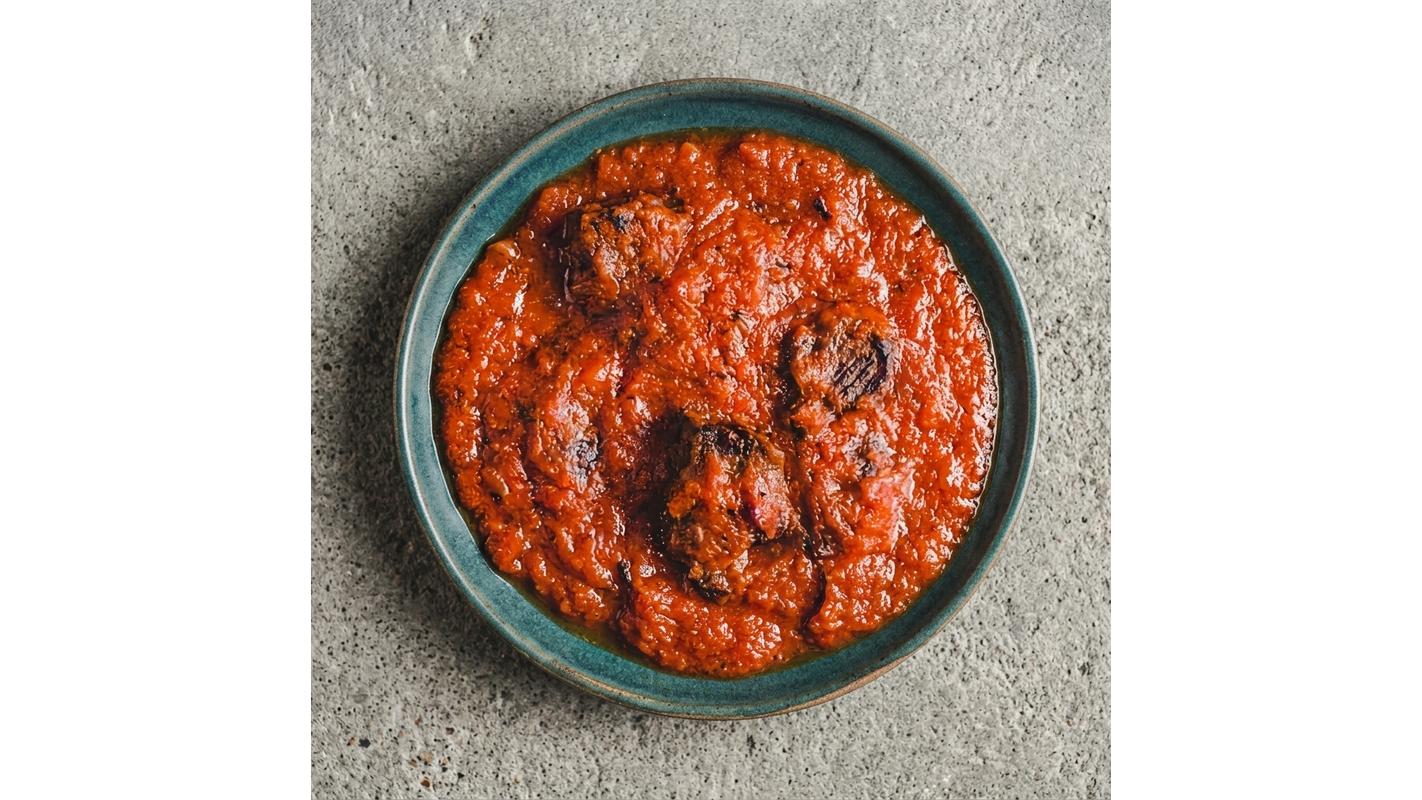 A Small Bowl Of Tomato Stew With 2 Proteins Of Choice
